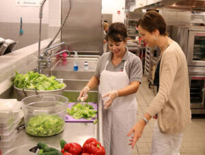 Schools two food preparers in a schools kitchen