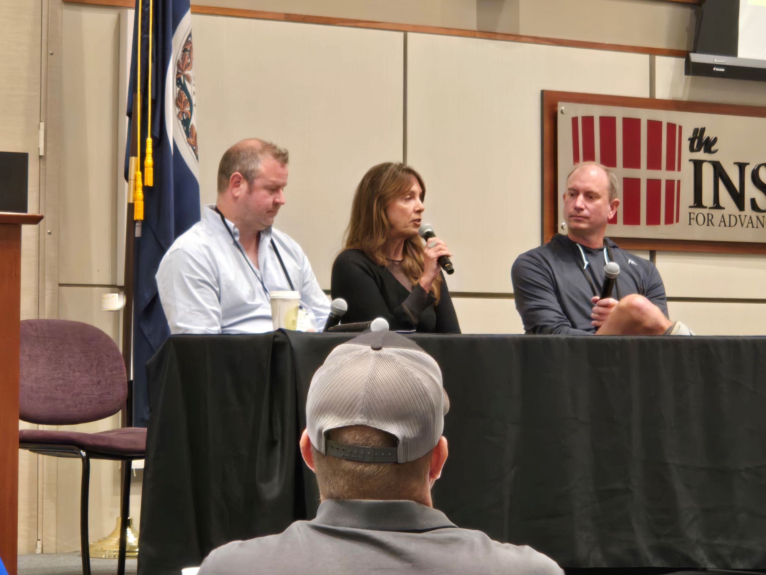 A panel of speakers at Indoor Ag Con East in Danville, VA talk on a microphone. 